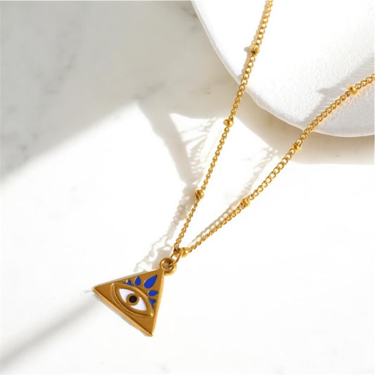 Gold necklace with an eye-shaped pendant on a white background
